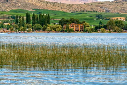 Osoyoos lake overview with resort on the shore on warm summer evening