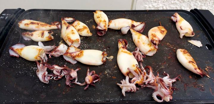 Typical Spanish dish of grilled squids with olive oil, salt and garlic