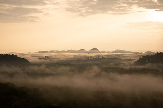 misty morning sunrise, Landscape view of Khao Na Nai Luang temple on peak mountain at Surat Thani Province, Southern of Thailand