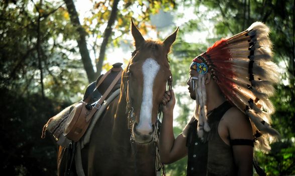 American Indian warrior, chief of the tribe. man with feather headdress and tomahawk, horse