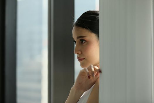 Side view of businesswoman looking through window.