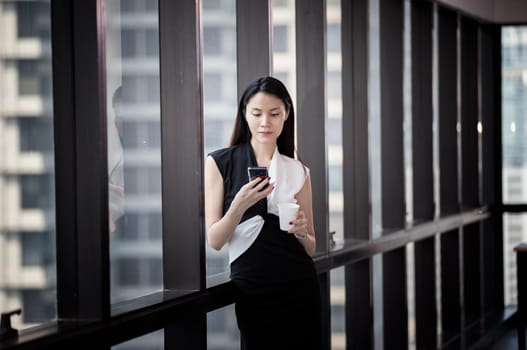 Side view of businesswoman looking through window.