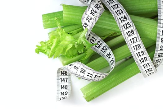 Celery and measure tape diet weight loss concept isolated on white background