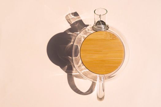 glass teapot with a hard shadow on a colored background. High quality photo