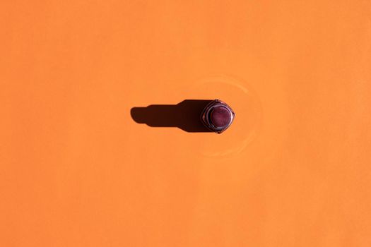 lipstick with a hard shadow on a colorful background. High quality photo