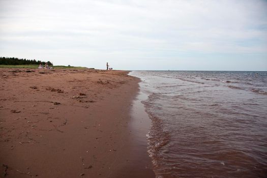 Kensington, PEI- July 27, 2019 - A few tourists and locals on the beach on a hot summer day in Prince Edward island 