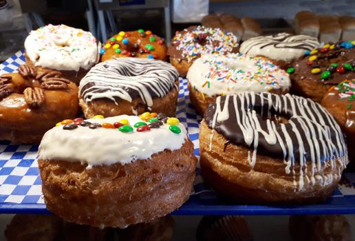  Beautifully decorated and iced fresh baked donuts 