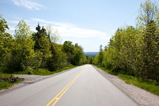 A road leads down from the top of a steep hill 