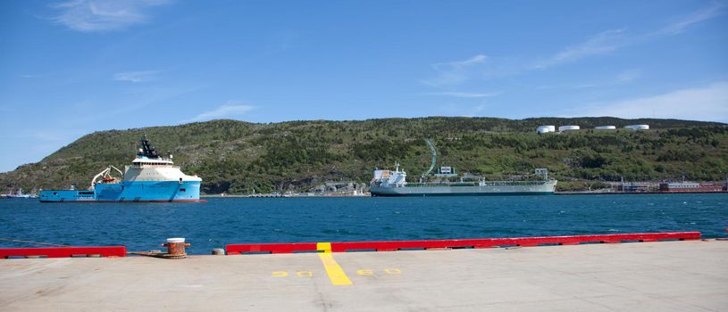  June 23, 2018- St. Johns, Newfoundland: Across the St. Johns, Harbour, the tug supply vessel Maersk Cutter is visible beside an Irving Refinery