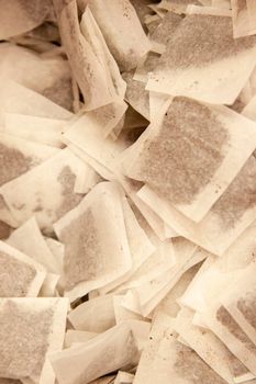 piles of tea in small white bags with holes for tea steeping and consumption 