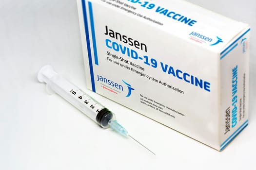 New York, USA, April 12th 2021: A syringe next to the Janssen Covid-19 vaccine box. Janssen is a subsiadiary company of Johnson and Johnson and devoloped the first single-shot Covid-19 vaccine