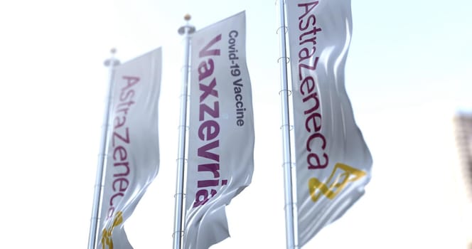 Cambridge, England, UK, march 30 2021: Three vertical flags with the Vaxzevria and AstraZeneca logo flying in the wind. Health and prevention. Vaxzevria is the AstraZeneca Covid-19 vaccine