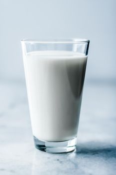 Dairy, healthy nutrition and breakfast concept - World Milk Day, full glass on marble table