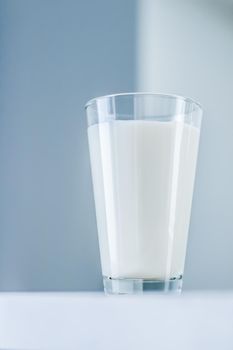 Dairy, healthy nutrition and breakfast concept - World Milk Day, full glass on marble table