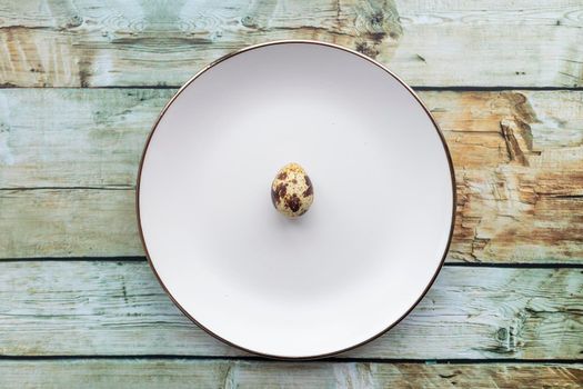 Quail eggs inside a decorative plate and on a background