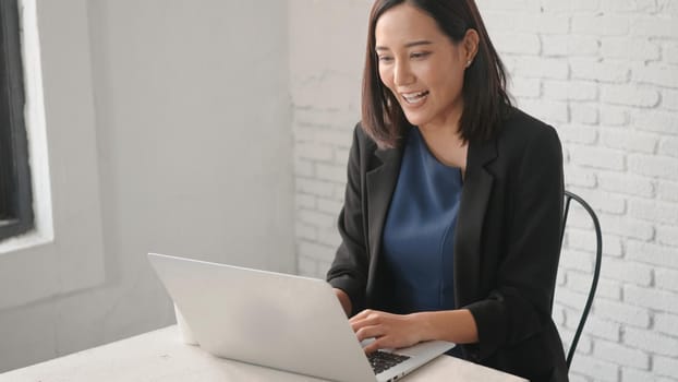 Happy Asian businesswoman video call with friends at home by laptop, Head shot business female call video conference with computer, online work from home, Healthcare and Social Distancing Concept