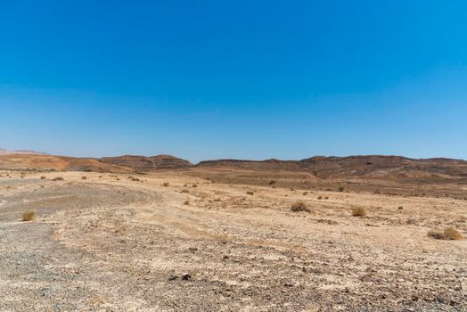 A view from the crater in the Ramon Crater. Arid desert view. White sands and a horizon of blue skies. Negev, Israel. High quality photo