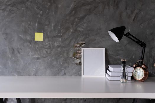 Workspace Mock up marble tabletop with picture frame , pencils. copy space desk with copy space for products display montage.