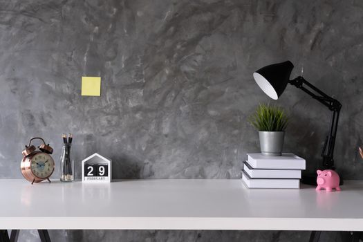 Cropped shot of minimal workspace with mock-up laptop, smartphone, decorations and copy space, work from home concept.