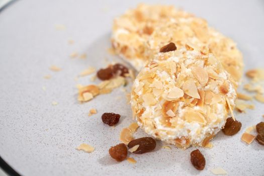 Close up of delicious dietary sweet cheesecakes sprinkled with raisins and nuts. Concept of appetizing cheesecakes with delicious filling home cooking. 