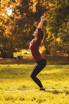 Beautiful woman doing yoga in the nature,Utkatasana/Chair Pose