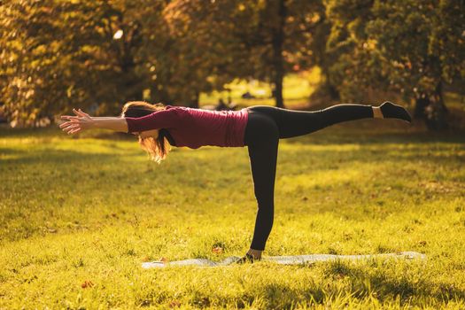 Beautiful woman doing yoga in the nature,Virabhadrasana III /Warrior Pose III