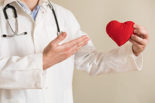 Image of male doctor showing heart shape.
