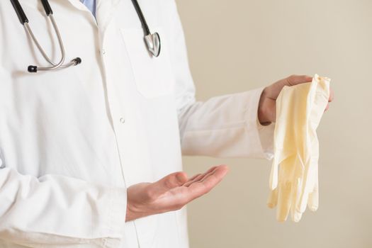 Image of male doctor showing protective gloves.
