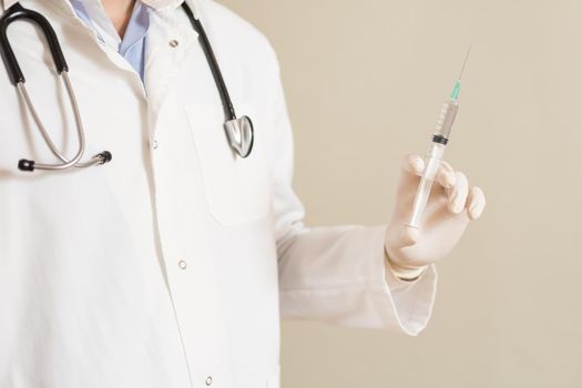 Image of male doctor holding  injection.