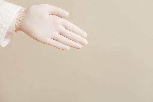 Image of close up hand in protective glove  of doctor showing.