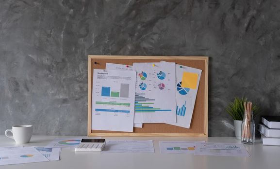 Business Workspace at home with laptop computer, financial document and office supplies on office workplace.
