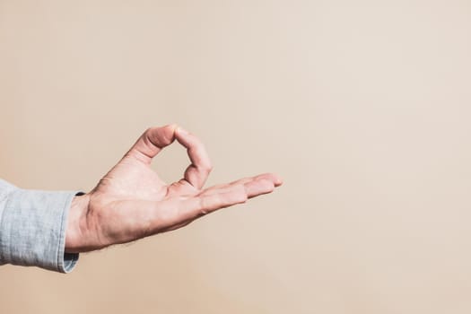 Close up image of  male hand meditating.