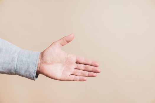 Close up image of male hand showing handshaking gesture.