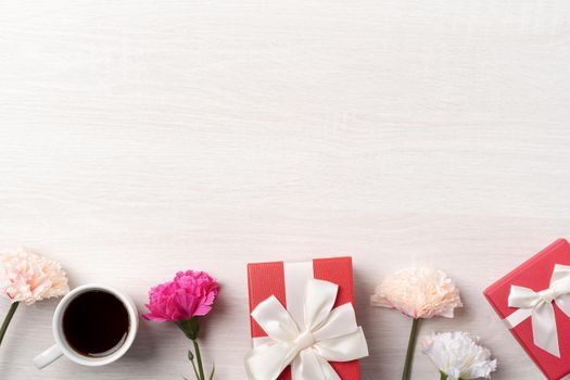 Mother's Day design concept. Top view of beautiful carnation flower and holiday gift idea with copy space.