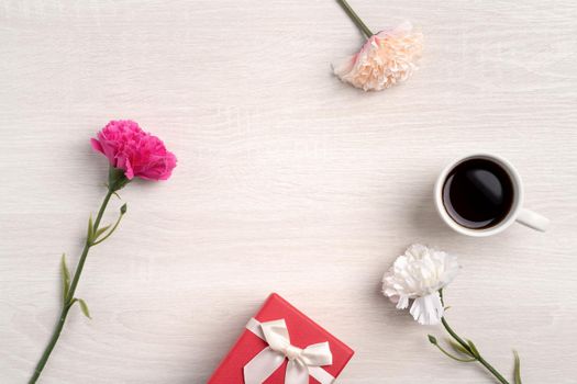 Mother's Day design concept. Top view of beautiful carnation flower and holiday gift idea with copy space.