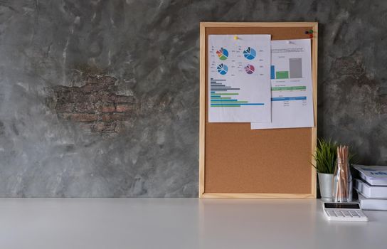 Business Workspace at home with laptop computer, financial document and office supplies on office workplace.