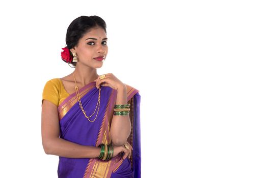 Beautiful Indian young girl posing in traditional Indian saree on white background.