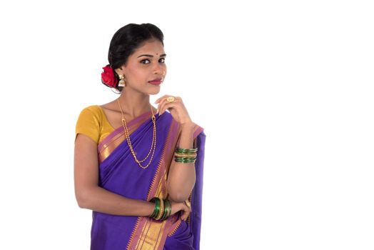 Beautiful Indian young girl posing in traditional Indian saree on white background.