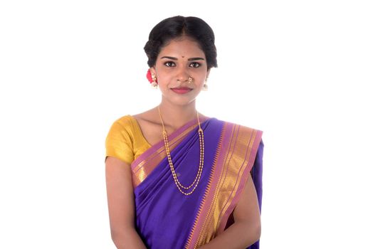 Beautiful Indian young girl posing in traditional Indian saree on white background.