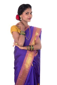 Beautiful Indian young girl posing in traditional Indian saree on white background.