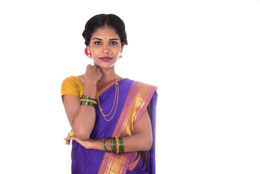 Beautiful Indian young girl posing in traditional Indian saree on white background.