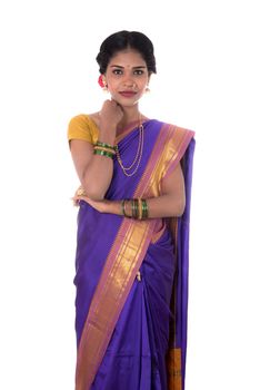 Beautiful Indian young girl posing in traditional Indian saree on white background.