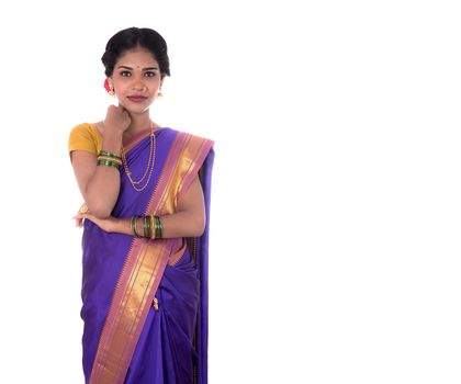 Beautiful Indian young girl posing in traditional Indian saree on white background.