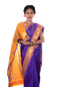 Beautiful Indian young girl posing in traditional Indian saree on white background.