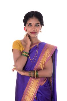 Beautiful Indian young girl posing in traditional Indian saree on white background.