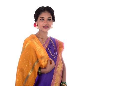 Beautiful Indian young girl posing in traditional Indian saree on white background.