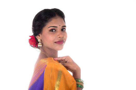 Beautiful Indian young girl posing in traditional Indian saree on white background.