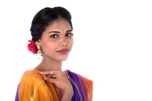 Beautiful Indian young girl posing in traditional Indian saree on white background.