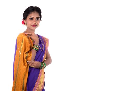 Beautiful Indian young girl posing in traditional Indian saree on white background.