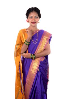 Beautiful Indian young girl posing in traditional Indian saree on white background.